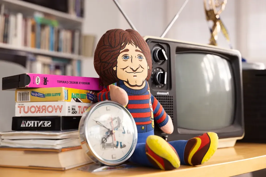 A figurine next to a TV.